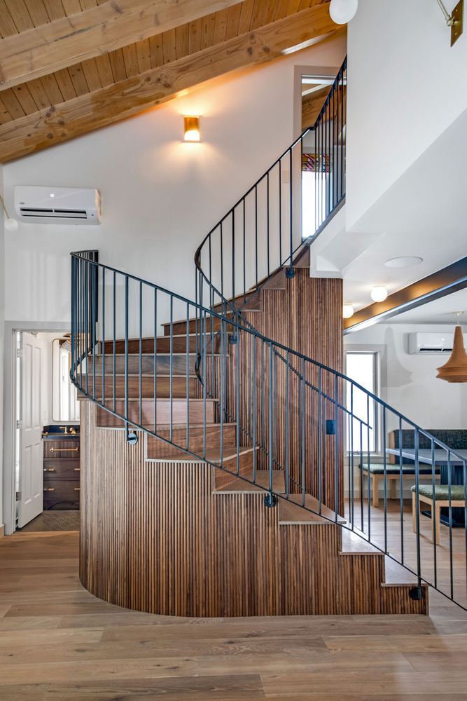 Stair: Curved walnut treads, steel balustrade